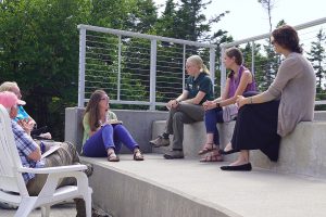 group of people discussing a topic outdoors