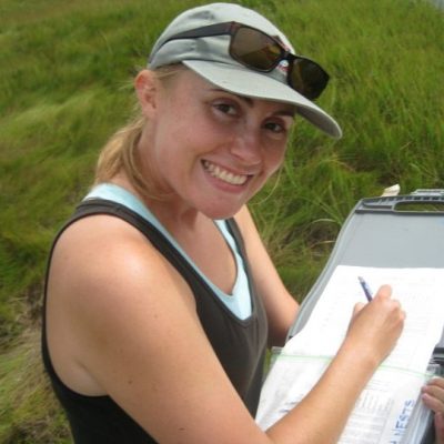 Kate Ruskin holding clipboard with grass in background