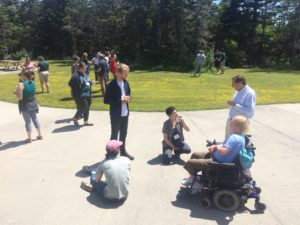 people in groups outside on concrete and lawn