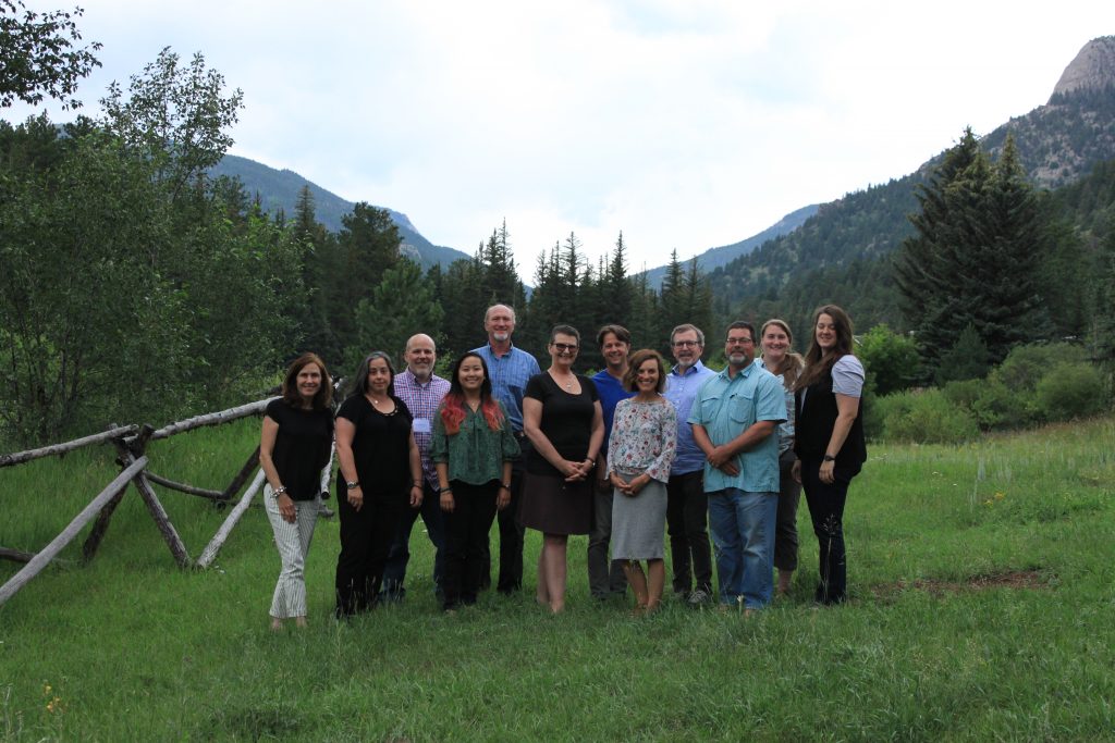 Meeting participants pose for a group photo outside